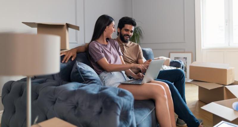 North Bay Hydro Event Bucket Rides Couple sitting on couch with moving boxes in and Starting an Account Online